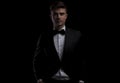 Portrait of relaxed young man wearing a black tuxedo Royalty Free Stock Photo