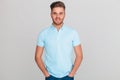 Portrait of relaxed young man wearing light blue polo t-shirt Royalty Free Stock Photo