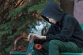 Portrait of relaxing teenager looking at skateboard in his hands Royalty Free Stock Photo