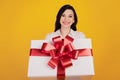 Portrait of reliable lovely cute girl receive gift present box on yellow background