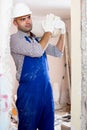 Portrait of repairer man with package of plaster