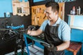 Portrait of a repairman in an apron as work clothes using a tablet to repair