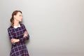 Portrait of resentful girl with head turned away, holding arms folded