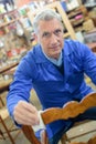 Portrait retired man standing at workshop and working Royalty Free Stock Photo