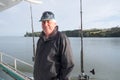 Portrait of a retired senior male tourist on a fishing charter b Royalty Free Stock Photo