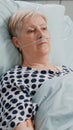 Portrait of retired woman with nasal oxygen tube laying in bed Royalty Free Stock Photo