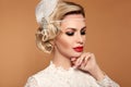 Portrait of Retro woman with red lips and wavy hairstyle, feather in head. Elegant lady in wedding white dress posing isolated on Royalty Free Stock Photo