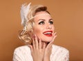 Portrait of Retro woman with red lips and wavy hairstyle, feather in head. Elegant lady in wedding white dress posing isolated on Royalty Free Stock Photo