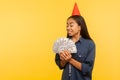 Portrait of rich successful woman looking at dollar banknotes with excited overjoyed expression, enjoying big money