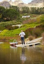 Portrait, river and a man drinking red wine on a pier outdoor in nature on his farm for agriculture. Water, drink and