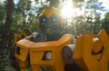 Portrait of a robot transformer Bumblebee standing among forest
