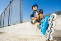Roller boy resting on the steps of skate park Royalty Free Stock Photo