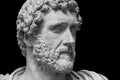 Portrait of Roman emperor Antoninus Pius  on a black background. Old beard man sculpture Royalty Free Stock Photo