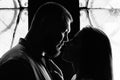 Portrait of a romantic couple in a backlight from a window or door, silhouette of a couple in a doorway with a backlight, couple