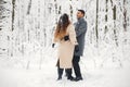 Portrait of a romantic couple dancing together in winter forest Royalty Free Stock Photo