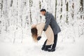 Portrait of a romantic couple dancing together in winter forest Royalty Free Stock Photo