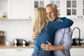 Portrait Of Romantic Elderly Couple Hugging In Kitchen Interior Royalty Free Stock Photo