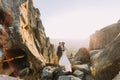 Portrait of romantic enloved newlywed couple in sunset lights on majestic mountain landscape with big rocks as backround Royalty Free Stock Photo