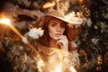 Portrait of a romantic girl in a blooming garden with elements of phantasmagoria. Royalty Free Stock Photo