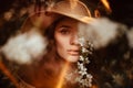 Portrait of a romantic girl in a blooming garden with elements of phantasmagoria. The concept of fantasy, fairy tales. Royalty Free Stock Photo