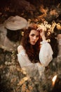 Portrait of a romantic girl in a blooming garden with elements of phantasmagoria, fantasy and fairy tales. Royalty Free Stock Photo