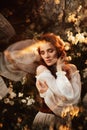 Portrait of a romantic girl, like a forest nymph, in a blooming garden with elements of phantasmagoria. The concept of Royalty Free Stock Photo