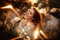 Portrait of a romantic girl, like a forest nymph, in a blooming garden with elements of phantasmagoria. The concept of Royalty Free Stock Photo