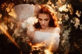 Portrait of a romantic girl, like a forest nymph, in a blooming garden with elements of phantasmagoria. The concept of Royalty Free Stock Photo