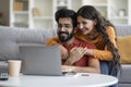 Portrait Of Romantic Indian Couple Using Laptop Together At Home Royalty Free Stock Photo