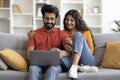 Portrait Of Romantic Indian Spouses Relaxing With Laptop At Home Royalty Free Stock Photo