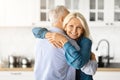 Portrait Of Romantic Older Spouses Hugging In Kitchen Interior Royalty Free Stock Photo
