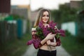 Portrait of a romantic smiling young woman with a bouquet of lilac outdoors shallow depth of field Royalty Free Stock Photo