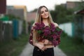 Portrait of a romantic smiling young woman with a bouquet of lilac outdoors shallow depth of field Royalty Free Stock Photo