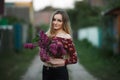 Portrait of a romantic smiling young woman with a bouquet of lilac outdoors shallow depth of field Royalty Free Stock Photo