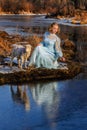 Portrait of romantic woman in a dress on the bank of the river Royalty Free Stock Photo