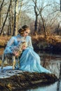 Portrait of romantic woman in a dress on the bank of the river Royalty Free Stock Photo