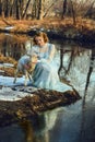 Portrait of romantic woman in a dress on the bank of the river Royalty Free Stock Photo