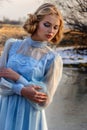 Portrait of romantic woman in a dress on the bank of the river Royalty Free Stock Photo