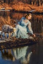 Portrait of romantic woman in a dress on the bank of the river Royalty Free Stock Photo