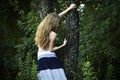 Portrait of romantic woman at the green forest