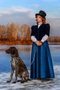 Portrait of romantic woman in vintage dress on the river