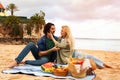 Portrait Of Romantic Young Couple Having Picnic On Beach Near Sea Royalty Free Stock Photo