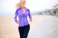 Portrait, runner or happy woman at beach running for exercise, training or fitness workout at sea. Sports, athlete and Royalty Free Stock Photo