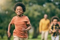 Portrait, running and children at a park with parents, freedom and playing in nature together. Love, energy and excited