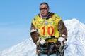 Portrait of running musher on background blue sky in winter sunny day