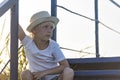 Portrait of rural boy in straw hat close up. Child is resting outdoors Royalty Free Stock Photo