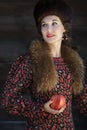 Portrait of Russian fashion style woman with red apple in arm Royalty Free Stock Photo