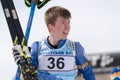 Portrait Russian sportsman biathlete Smolyakov Danila at finish after rifle shooting and skiing. Regional youth biathlon