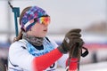 Portrait of Russian sportswoman biathlete Maria Babkina at finish after rifle shooting and skiing. Junior biathlon