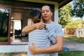 Portrait of 30s happy young adult Asian couple embracing while holding a house key. Husband and wife real estate owners Royalty Free Stock Photo